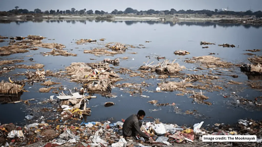 Polluted Yamuna River with floating waste highlighting water pollution and its impact on human health and DNA.